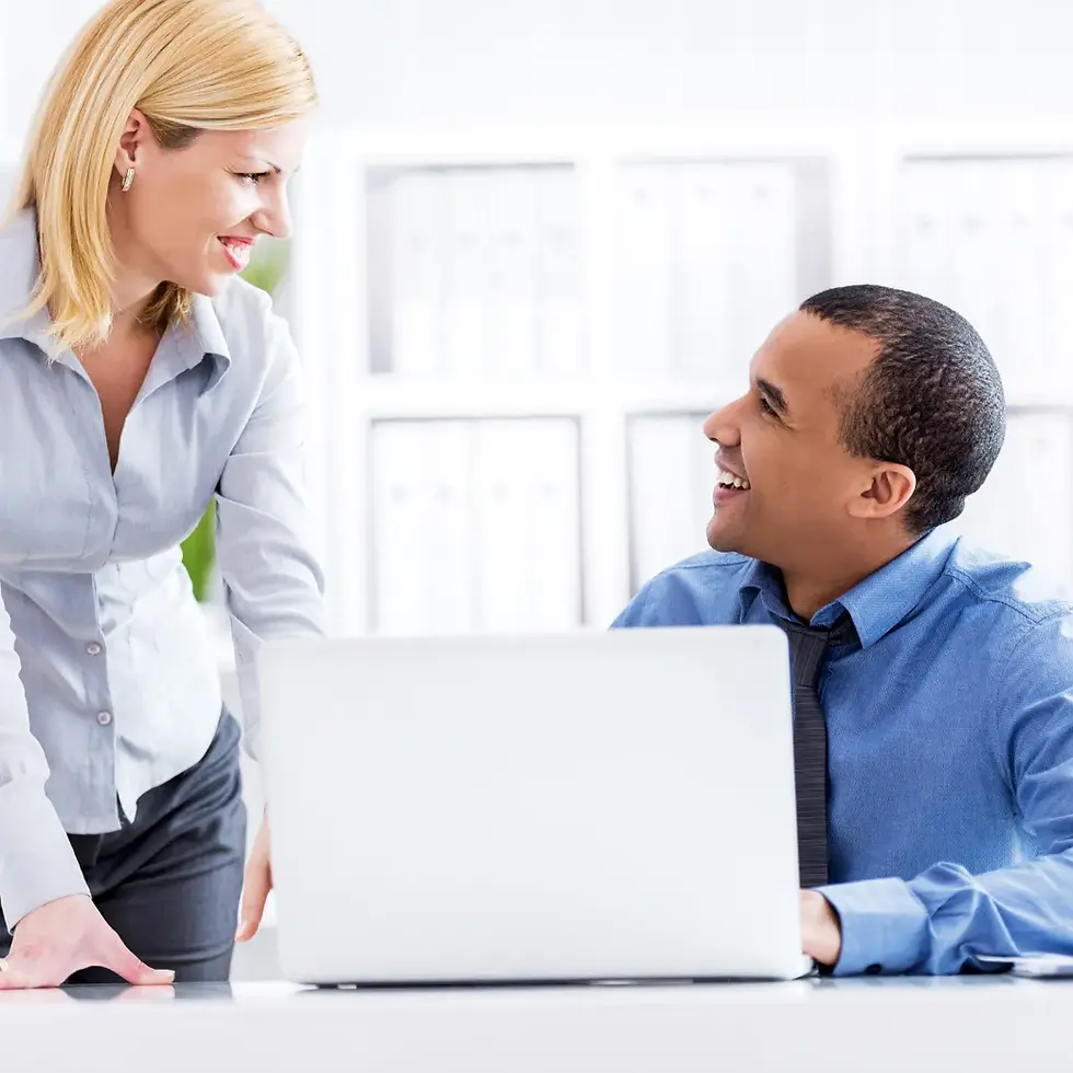 Executive Assistant and colleague collaborating at a laptop