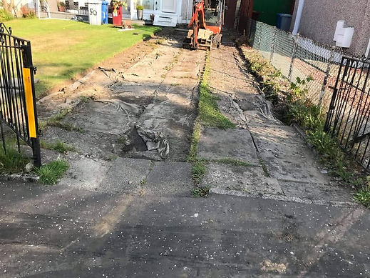 Long domestic driveway undergoing complete site clearance and excavation with a mini digger at work