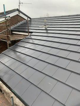 A sleek, modern roof with dark gray tiles