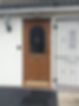 Wooden front door with decorative frosted glass panel and brass mail slot
