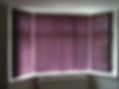 Purple vertical blinds on window