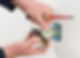 A person uses a screwdriver to wire a wall electrical socket