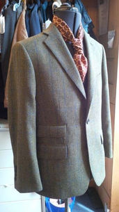 Mannequin wearing a tweed blazer with a brown patterned scarf