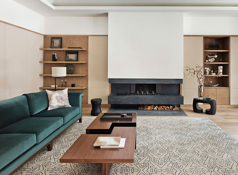 Modern living room with a teal sofa, geometric rug