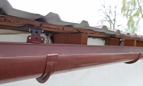 Gutter under roof shingles