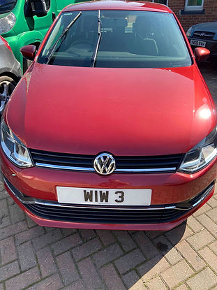 Red Volkswagen car with sleek design and shiny finish