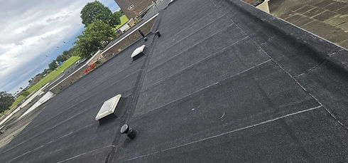 High angle view of black bitumen felt flat roof installation on property