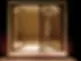 Illuminated glass doors slightly open, revealing a softly lit, empty room with a minimalist design