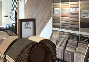 Carpet showroom with wool-rich samples displayed on racks