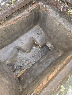A rectangular stone pit or structure with a step-like formation inside