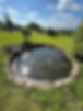 A small, serene pond with lily pads surrounded by a stone border