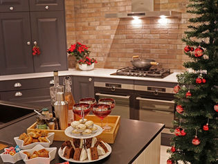 Festive kitchen with a Christmas tree and red ornaments
