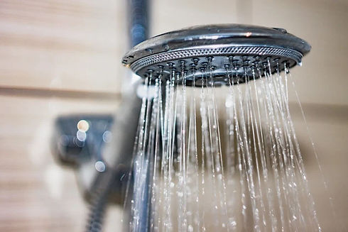 Close-up of a showerhead with water streaming down