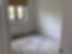 An empty room with beige carpet, white walls