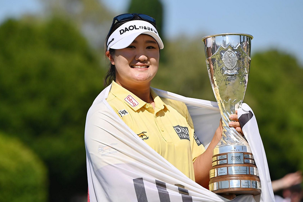 Champion Yoo Hae-ran lifts the trophy, draped in the South Korean flag and drenched in champagne.