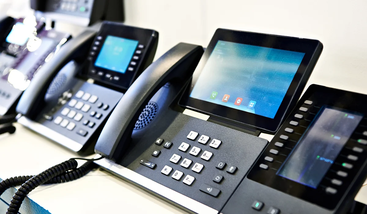 VoIP Phones lined up and connected.webp