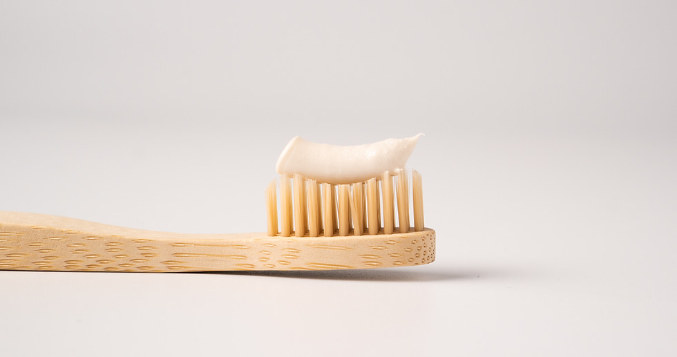 Wooden eco toothbrush with toothpaste on a white background. Bamboo toothbrush