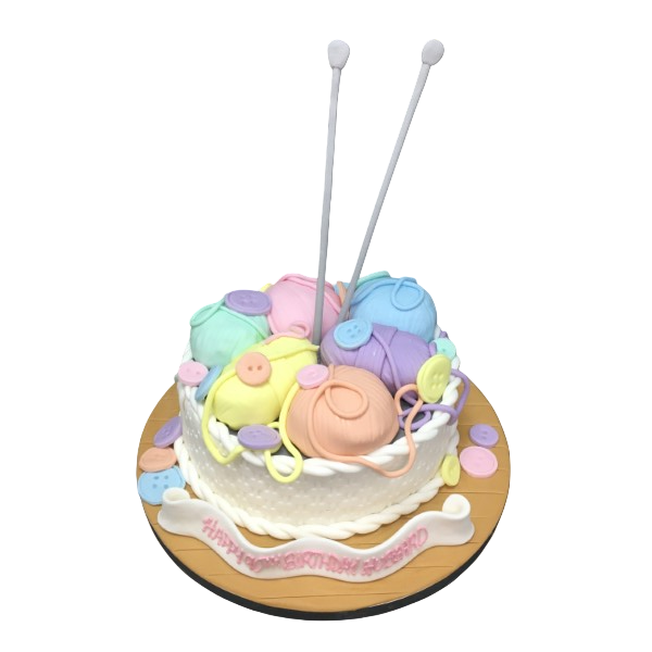 A charming and detailed cake decorated to look like a colourful knitting basket, perfect for themed parties and celebrations.