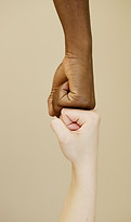 Two hands fist‑bumping to symbolize camaraderie, unity, and mutual support.