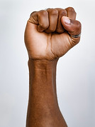 Single raised fist symbolizing integrity, strength, and unwavering personal values.