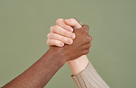 “Two hands clasped together in a firm grip symbolizing teamwork, unity, and mutual support.