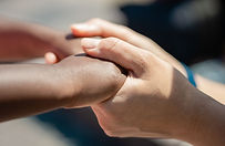 “Two sets of hands gently meeting to symbolize understanding, empathy, and emotional connection.