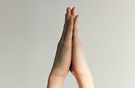 Hands held in a prayer stance symbolizing humbleness.