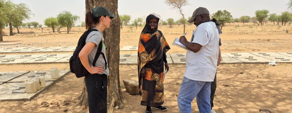Four people standing near a tree