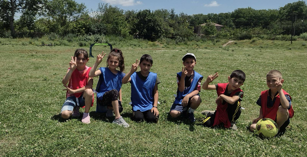 a young soccer team poses for a photo on the field