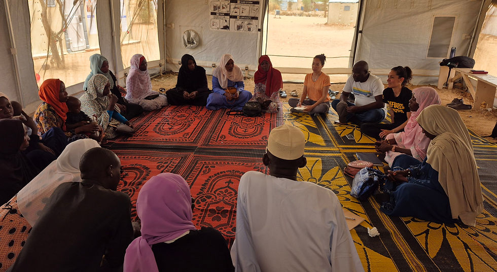 Community members sitting on the floor in a circle