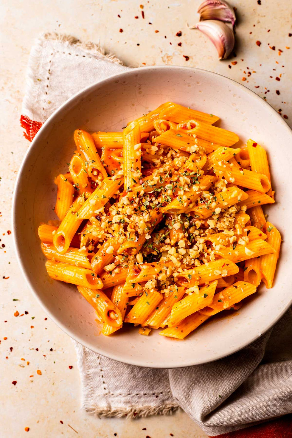 Delicious penne pasta in creamy tomato sauce, topped with nuts
