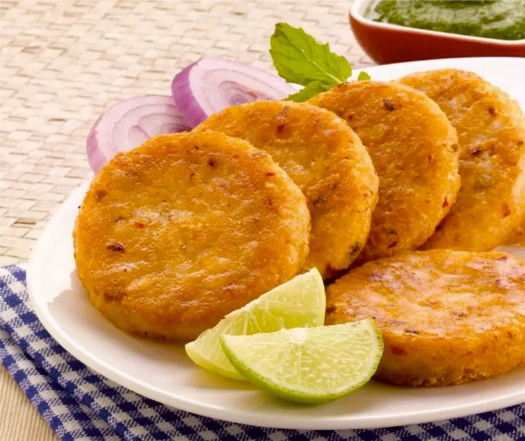 Crispy potato patties, lime wedges, onions