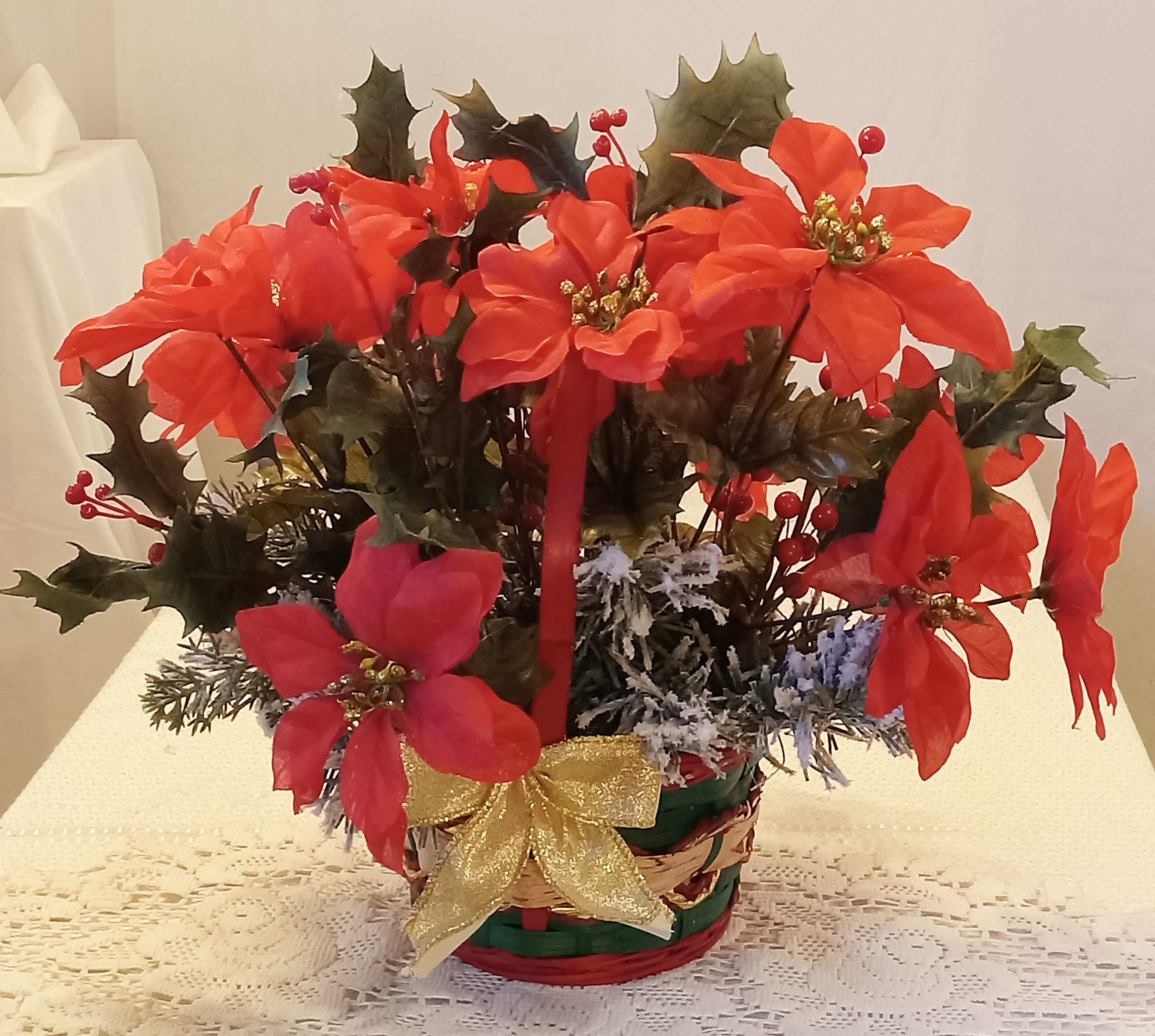 Red Flowers In A Green Basket Christmas Arrangement