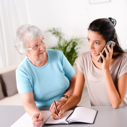 Elderly lady with carer on phone