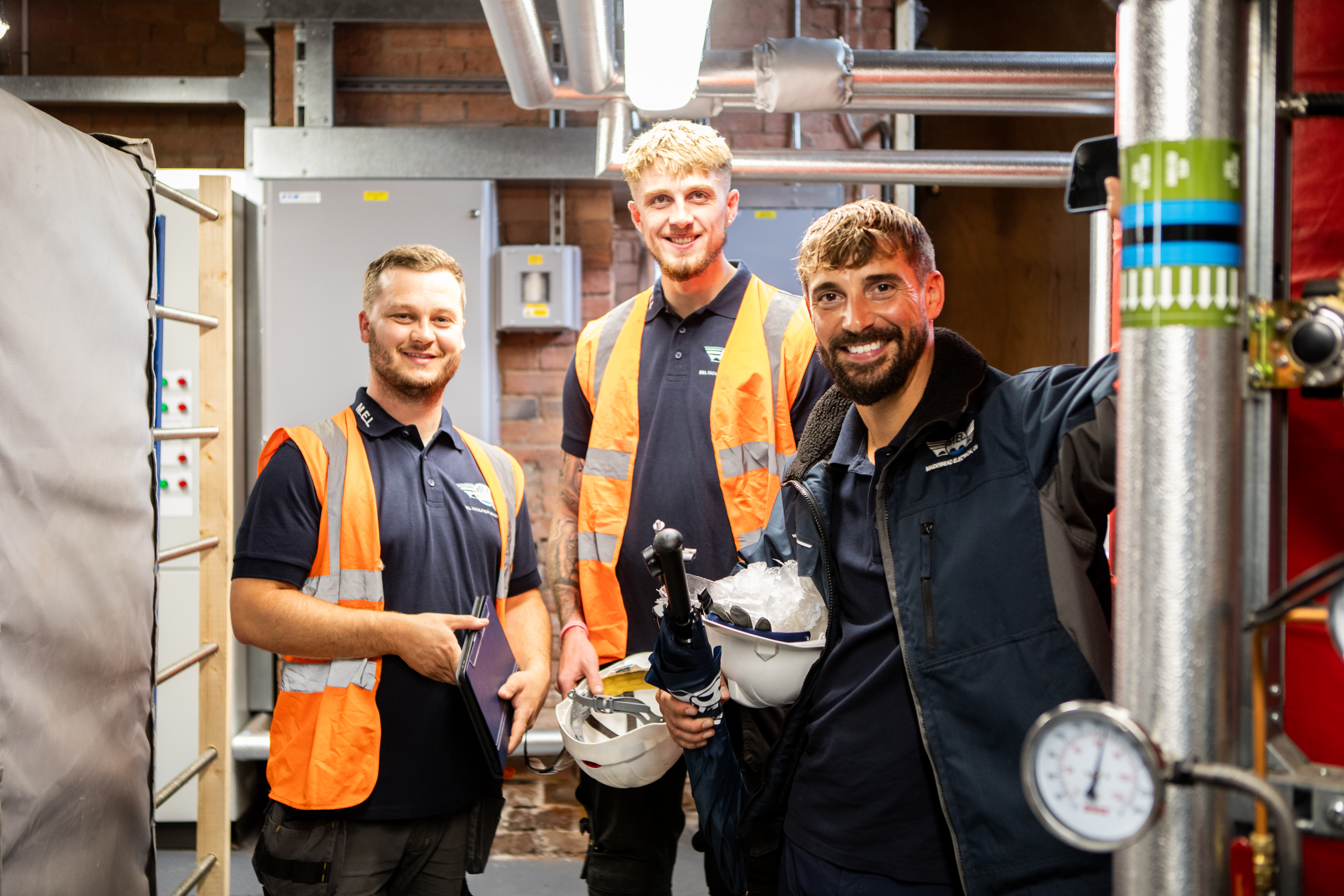 Three maidenhead electrical engineers working on site at a commerical building