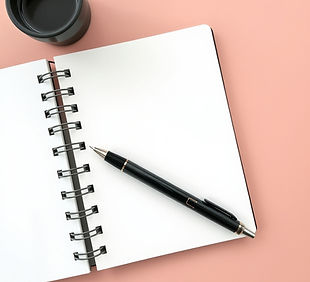 A spiral journal with a pen with a neutr