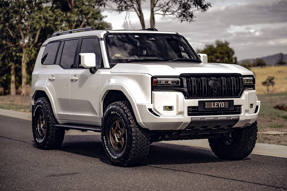 Toyota Land Cruiser Prado 250 Kakadu upgraded with LEYO forged bronze and black wheels and all-terrain tires on a scenic road.