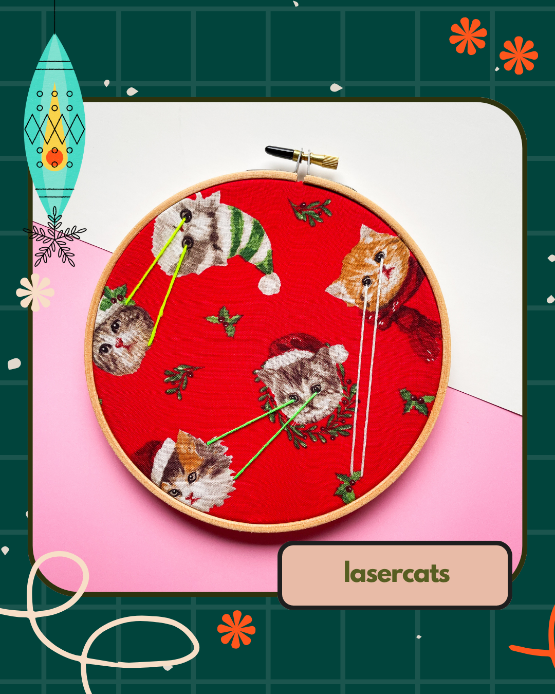 Embroidery hoop with cats wearing Christmas hats and the text 'lasercats'.
