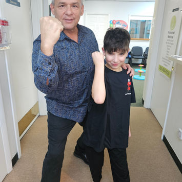 Man and boy pose with fists raised