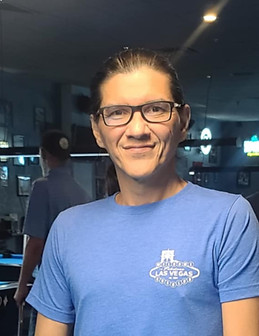 Smiling man wearing glasses and a blue shirt