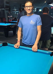 Man smiling at pool table