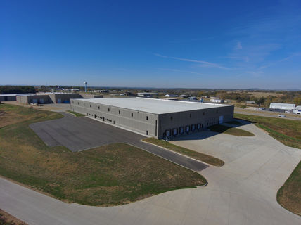 Aerial view of commercial building, blue sky background, Vector Drone Service.