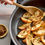 Thumbnail: Ground cloves sprinkled on apples for an apple pie recipe