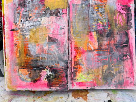 An open sketchbook with a mixed media painting with pink, yellow and black marks. It is non-representational abstract art.
