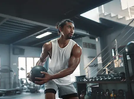 man-holding-medicine-ball.webp