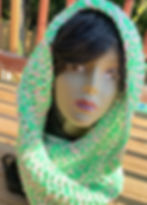 This scarf has the colors of pink and green and it wraps around the head.