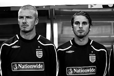 david beckham and david bentley stand side by side wearing england training tops, image is in black and white