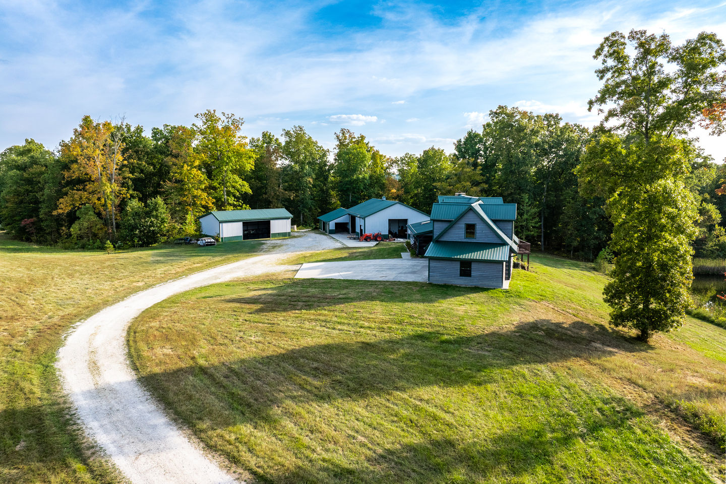 Drone image showcasing custom log home roofline and wooded surroundings in Nashville Indiana.