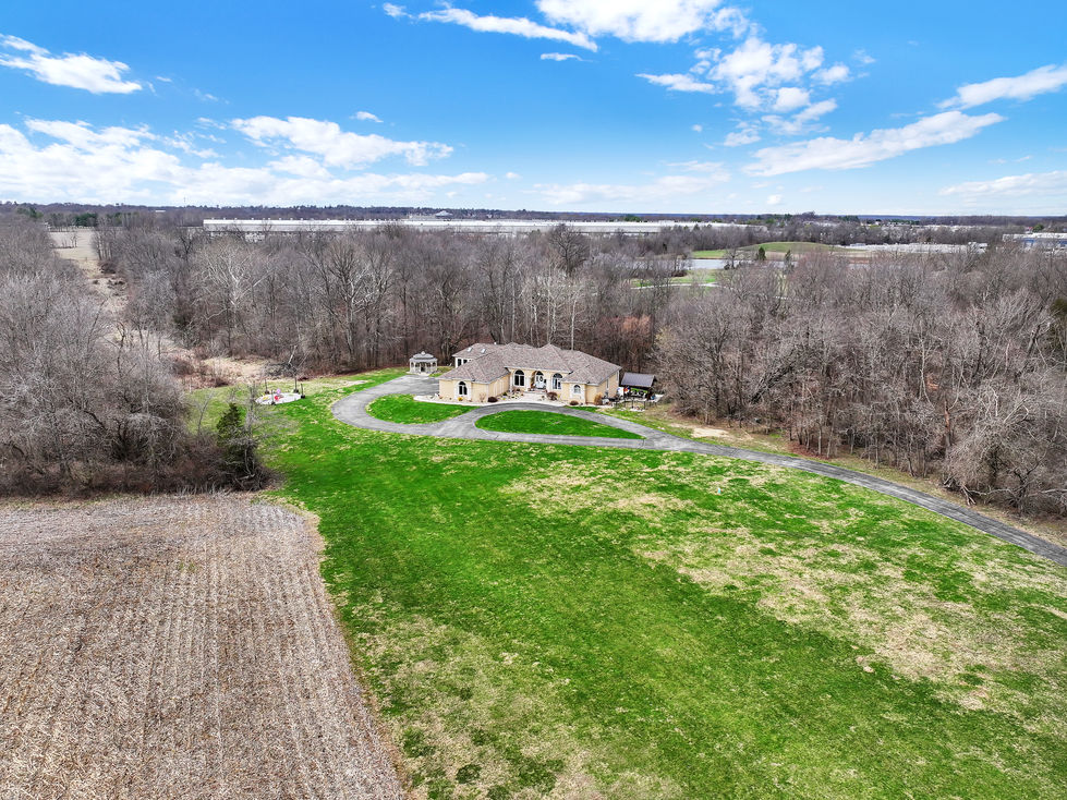 Aerial drone photo of luxury home in Greencastle Indiana with surrounding landscape