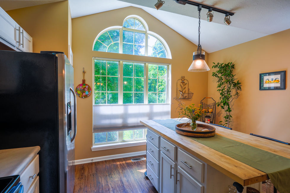 Professional real estate photography of eat-in kitchen area with natural light in Mooresville property.